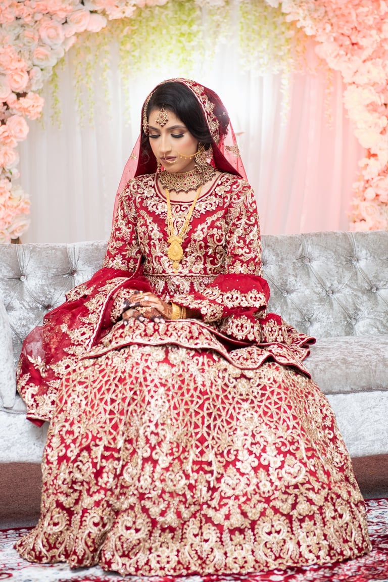 asian bride in traditional red dress with gold embroidery, full body photo, bride looking down, light and airy photo  