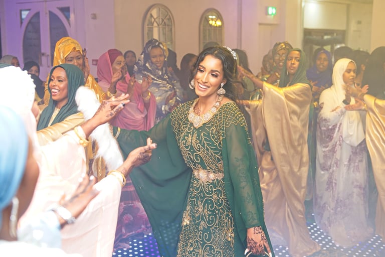 happy Somalian bride dancing with wedding guests, all dressed in vibrant traditional clothes