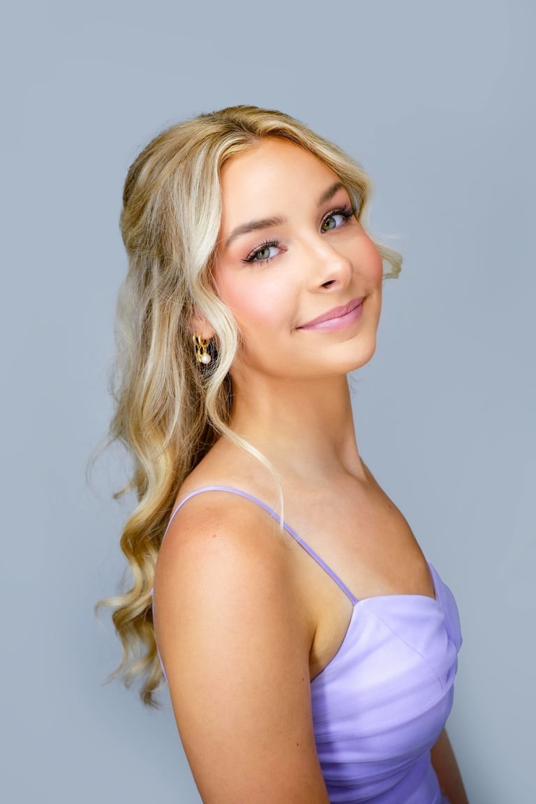 Bridesmaid with blonde half up hairstyle in loose waves wearing lavender dress, soft makeup look for wedding day style.