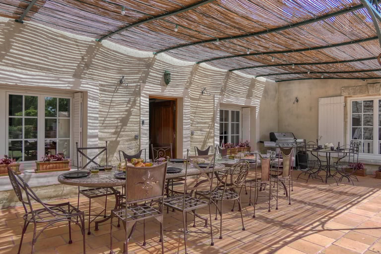 Spacious terrace of a Provençal mas in Drôme, ideal for group stays and outdoor dining in the mas L'Enclos du Soleil le Vent