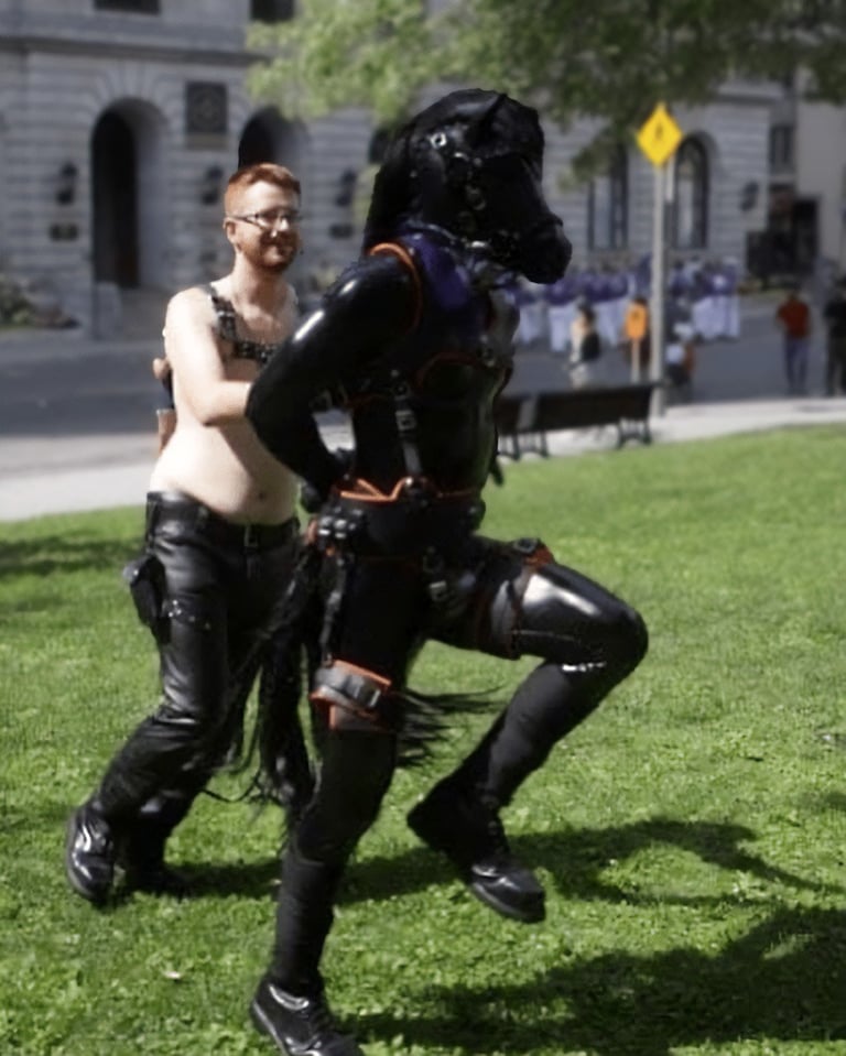 A man leading another man dressed as a horse.