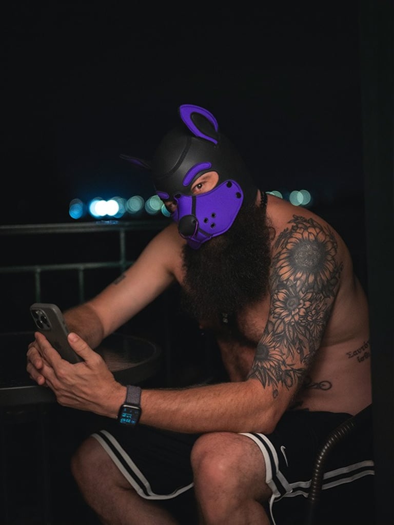 Man in pup mask checking his smartphone.