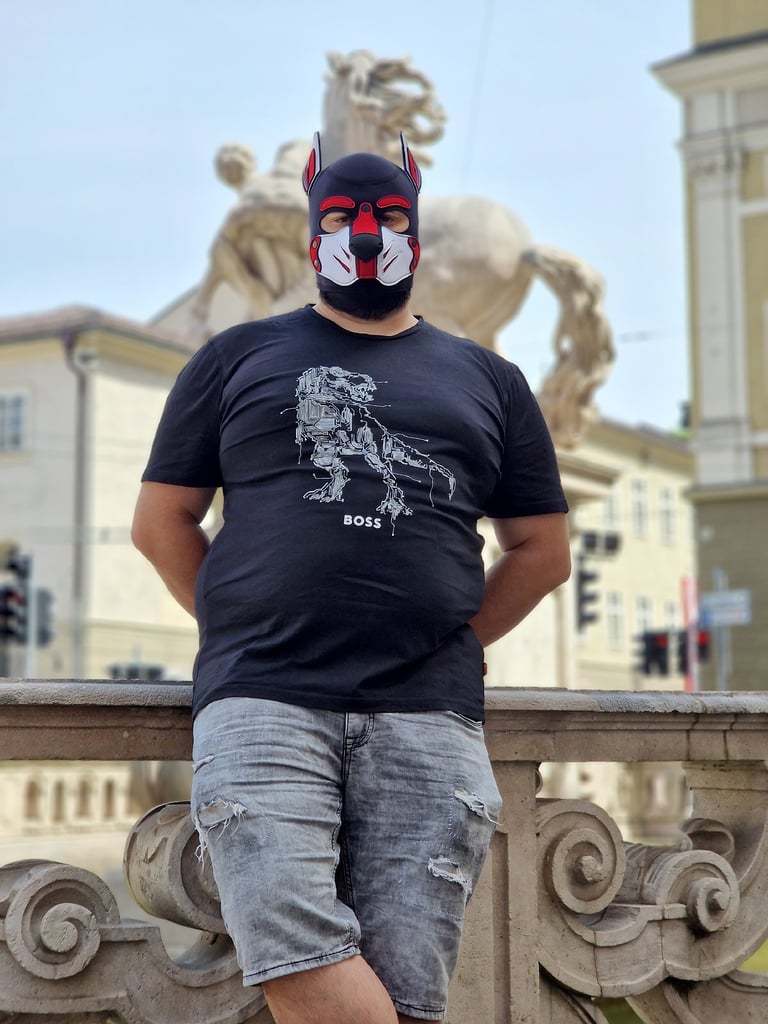A man posing in a pup mask.