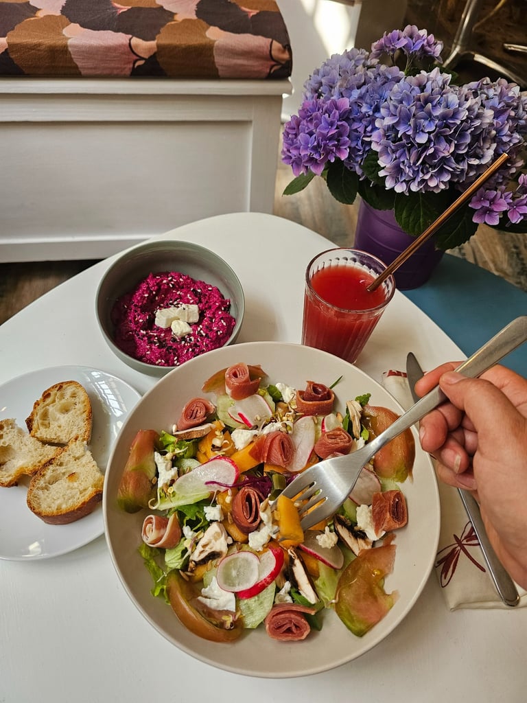 Gourmet salad at Mlle & Potts Co. with cured ham, fresh goat cheese, radishes and beet hummus