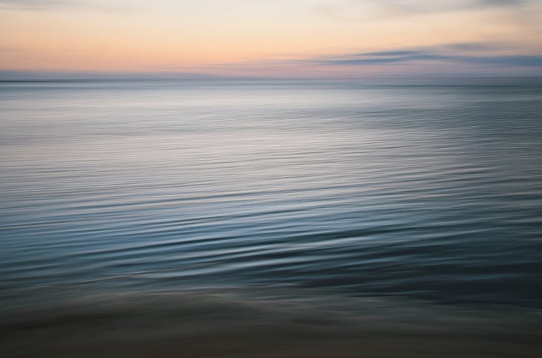 Soft waves shot in ICM on a calm ocean at sunset in Mauritius with gentle pastel hues