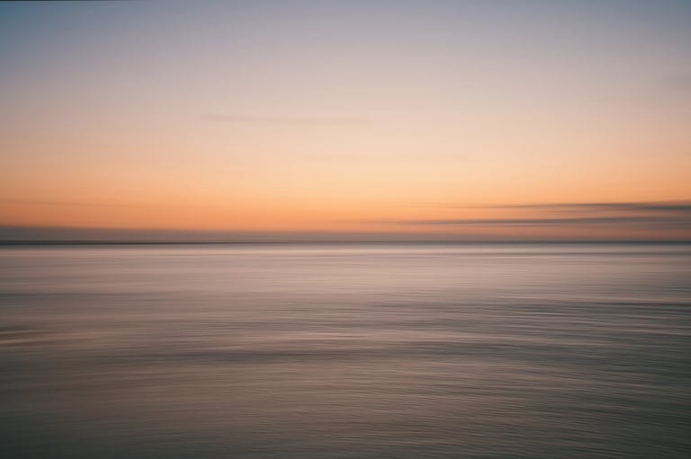 Minimalist ICM sunset over calm ocean waters with soft pastel colors in Mauritius