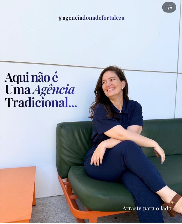 A smiling woman sitting on a green couch in a modern marketing agency setting.