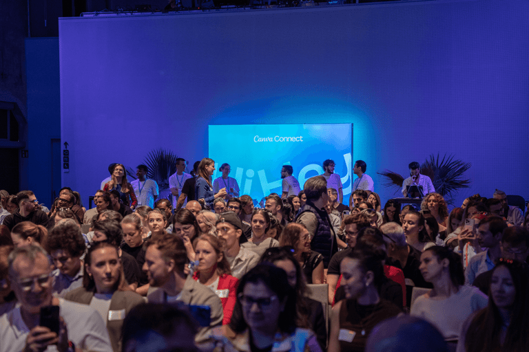 A crowd at an indoor Canva connect event in Vienna.