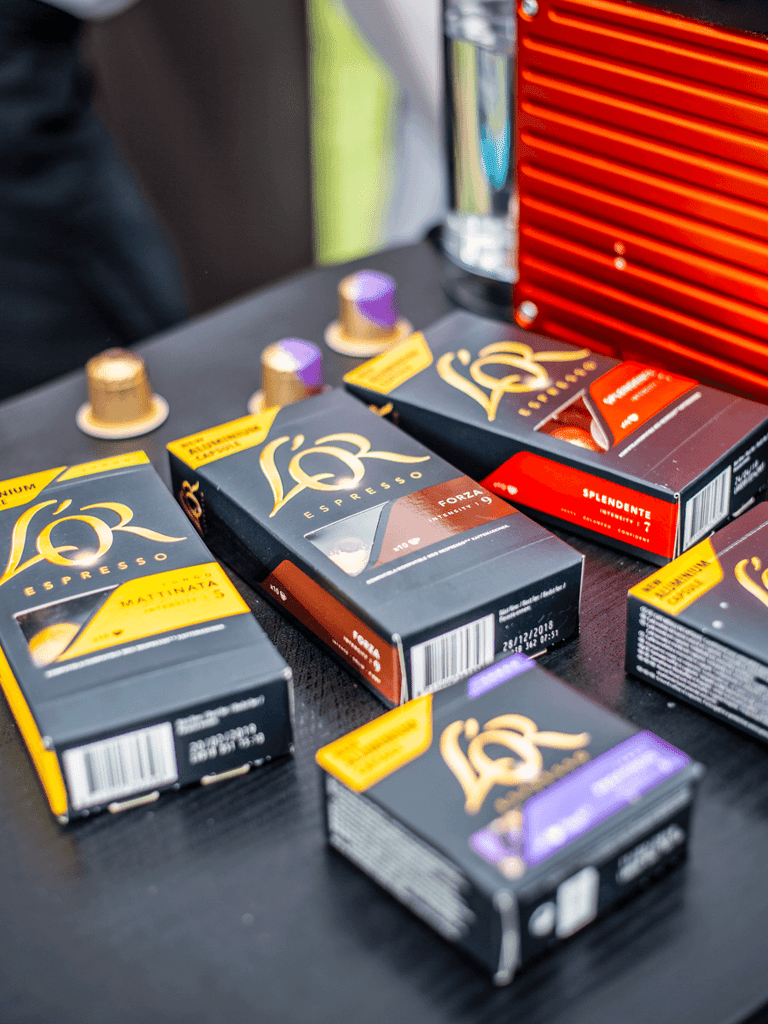 Lor coffee boxes placed on a table at an event outdoors.
