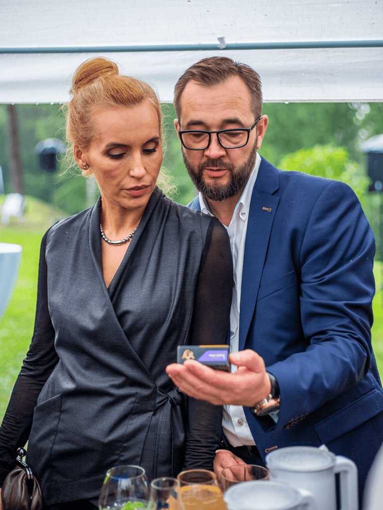 Stylish middle aged couple standing close together looking into a box.
