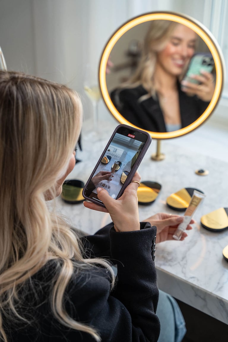 Woman recording a video on her phone of makeup brand.