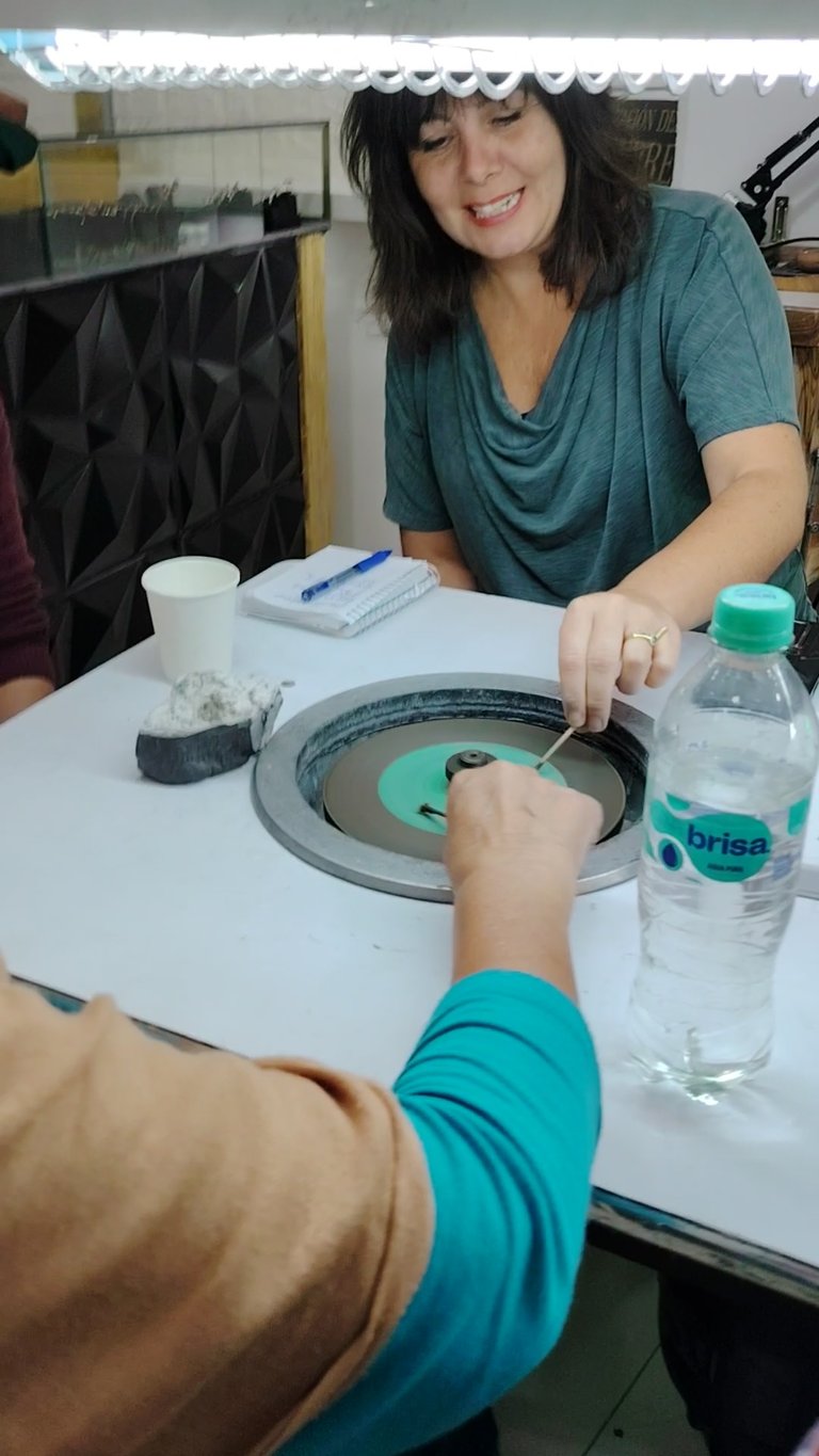 Tourist in Bogota carving his own natural emerald in a workshop