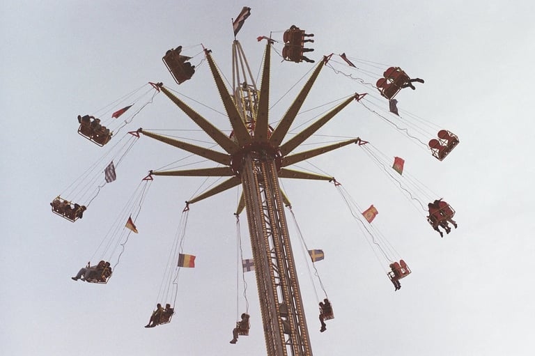 Star flyer swing carousel ride against a clear sky in Delft. Unedited 35mm film SOOC photography.