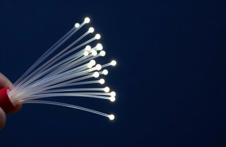Macro photography of glowing fiber optic nodes on a deep navy background, symbolizing high-speed connectivity and data systems.