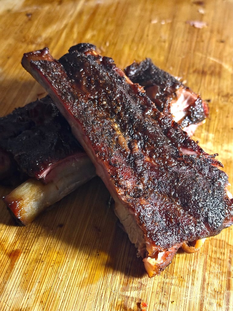 Smoked BBQ ribs with crispy bark on a cutting board, Holy Smoke & Fire Northern Virginia
