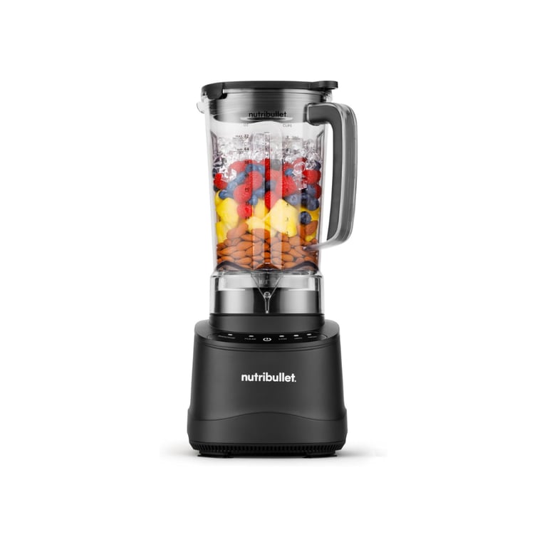 A black NutriBullet blender filled with almonds, fresh fruit, and ice for making a healthy smoothie.