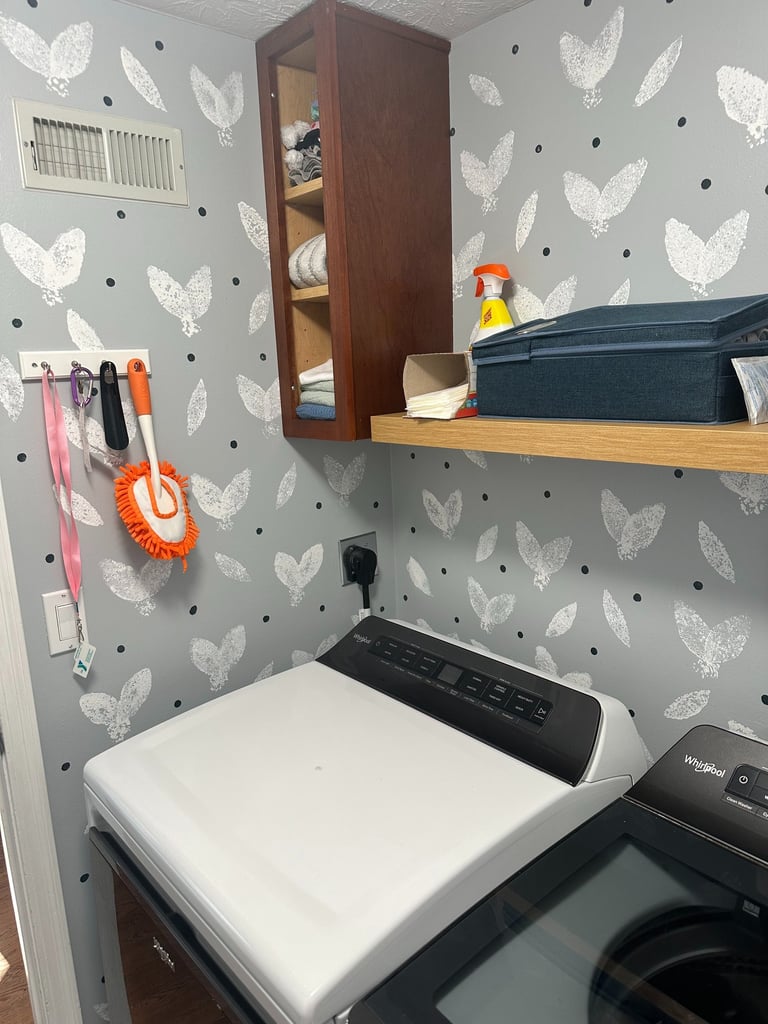 Finished DIY sponge-stamped accent wall in small laundry room