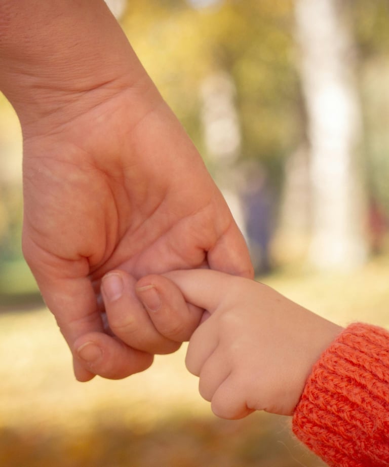 A worried mom holding her child’s hand before pediatric surgery