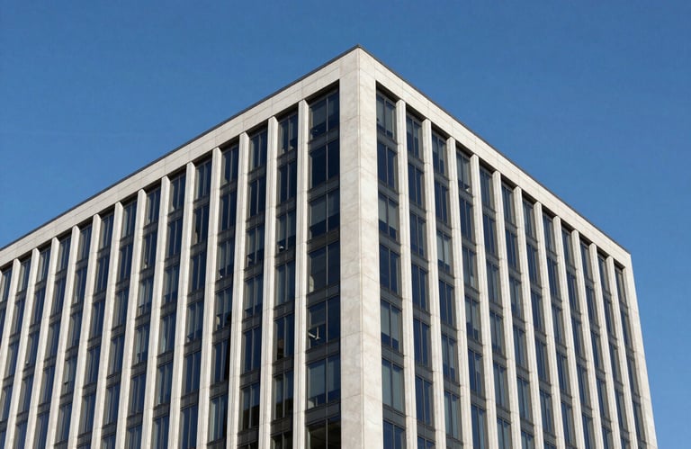 A clean, sharp-focus photograph of a contemporary office building exterior in North America. The architectural lines are strong, reflecting a clear blue sky and conveying stability and corporate strength.