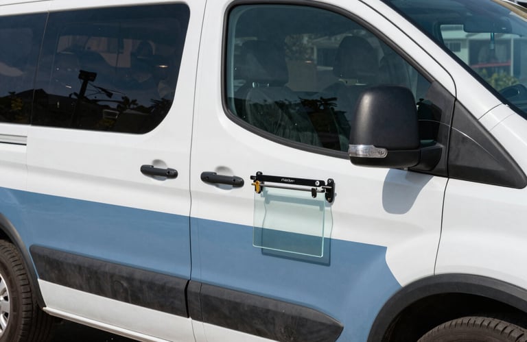 A modern North American / US mobile service vehicle equipped with professional glass repair tools, seen from a side profile, daylight, slate blue and white palette.