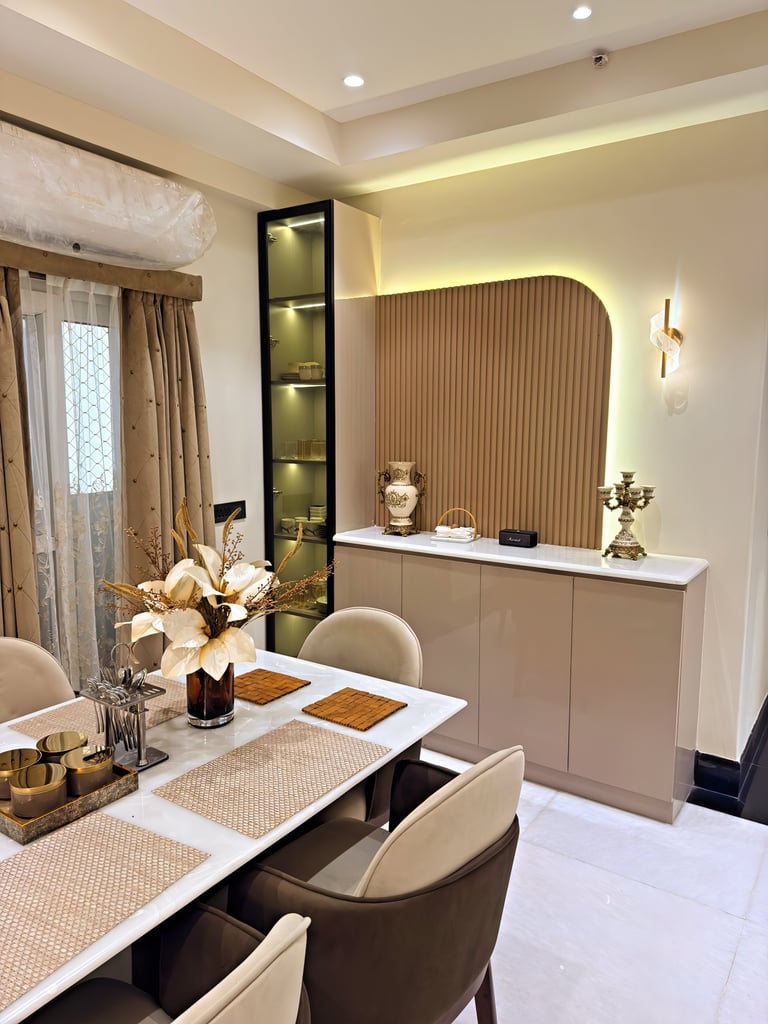 Modern luxury dining room featuring a white marble table, fluted wall paneling, and elegant ambient lighting.