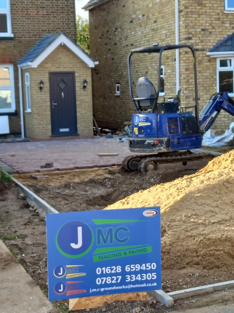 Professional driveway block paving installation by JMC Fencing and Paving featuring a blue mini excavator.