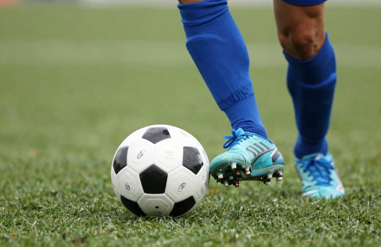Close-up of a soccer player's feet with a ball on a green turf, focus on precision and technique, brand colors #1A2B3C and #8FAABF present.
