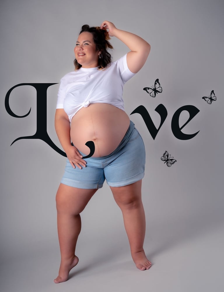 a pregnant woman in a white shirt and shorts