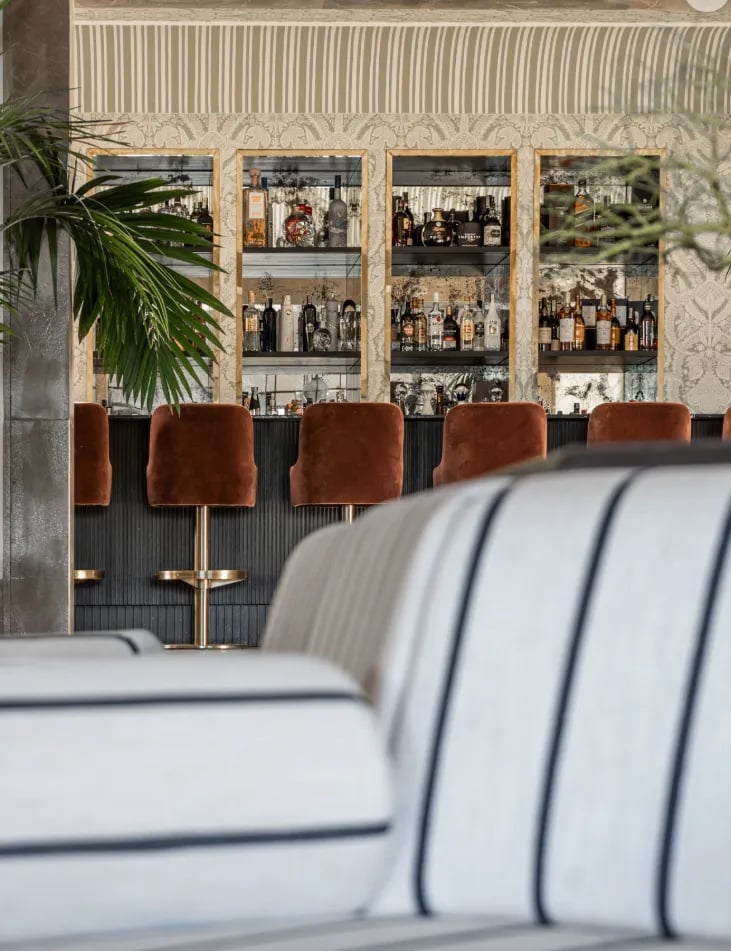 Cocktail bar at Villa La Gratitud with custom cabinetry and velvet seating