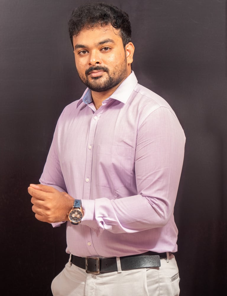 a man in a purple shirt and white pants