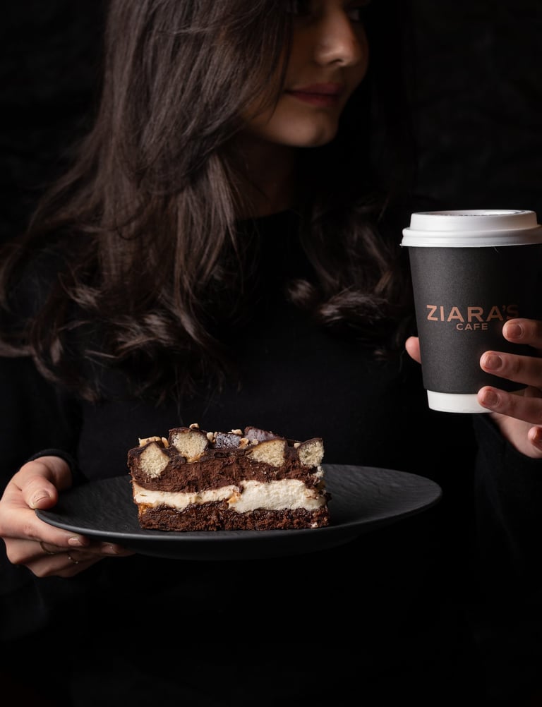 woman eating a dessert and drinking coffee