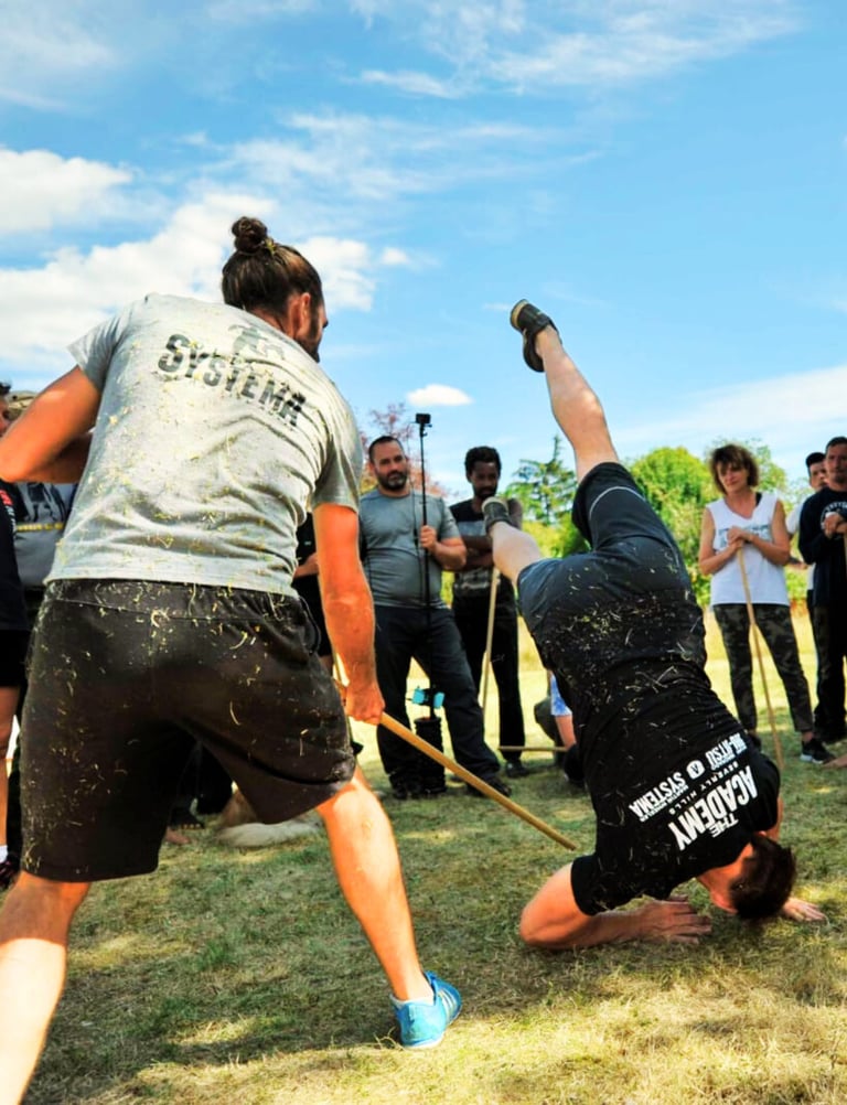 a man doing a handstand on a man's hands - martin wheeler systema