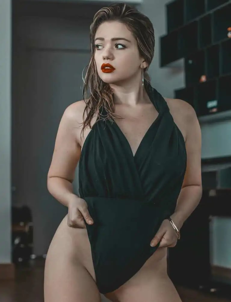 a girl on a black dress look away 