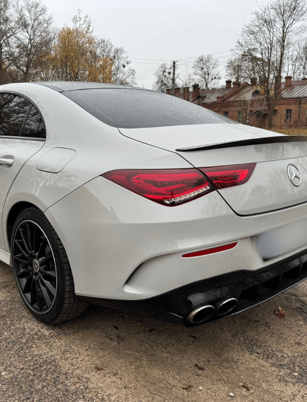 an Enlab mercedes cla parked in a parking lot
