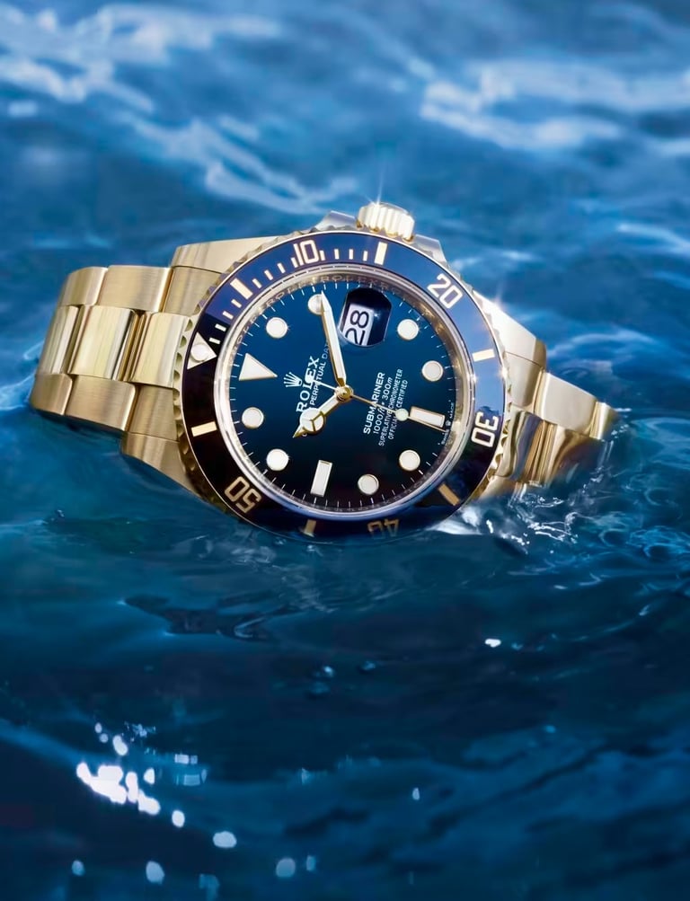 Gold Rolex Submariner luxury dive watch floating on water, showcasing its waterproof design.