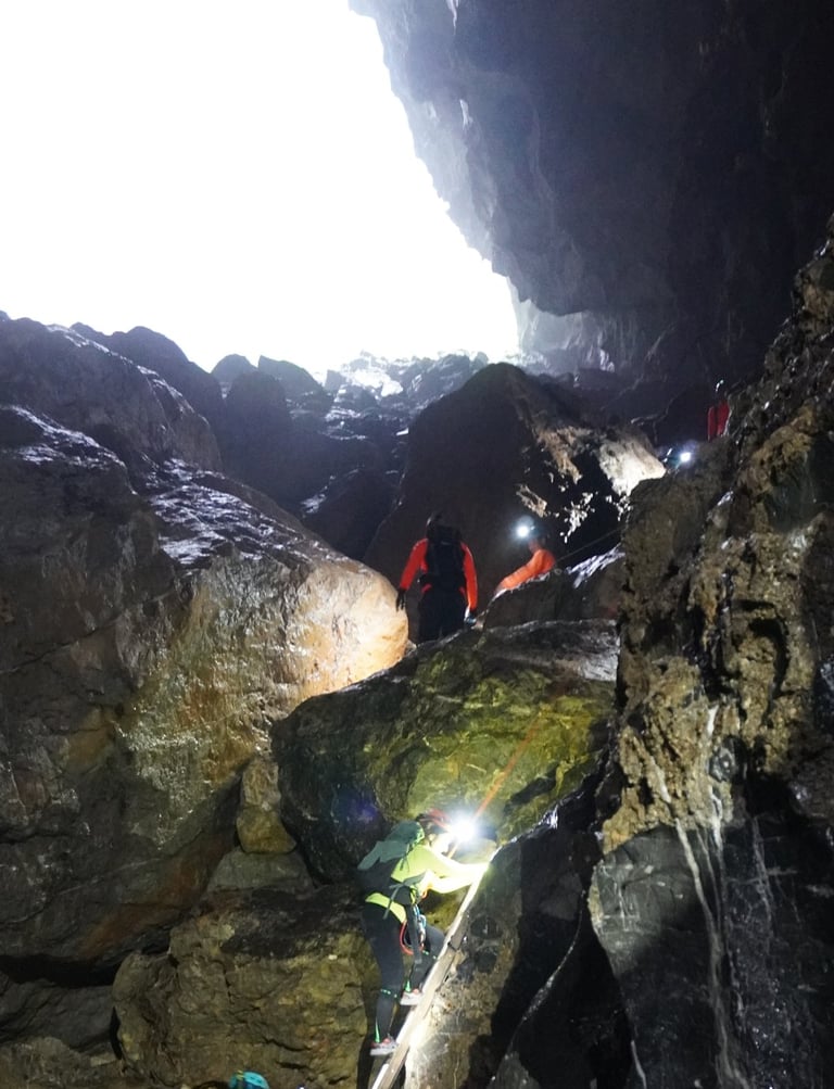 Nick Billington climbing through a boulder field in Hang Son Doong Cave to get to doline 1