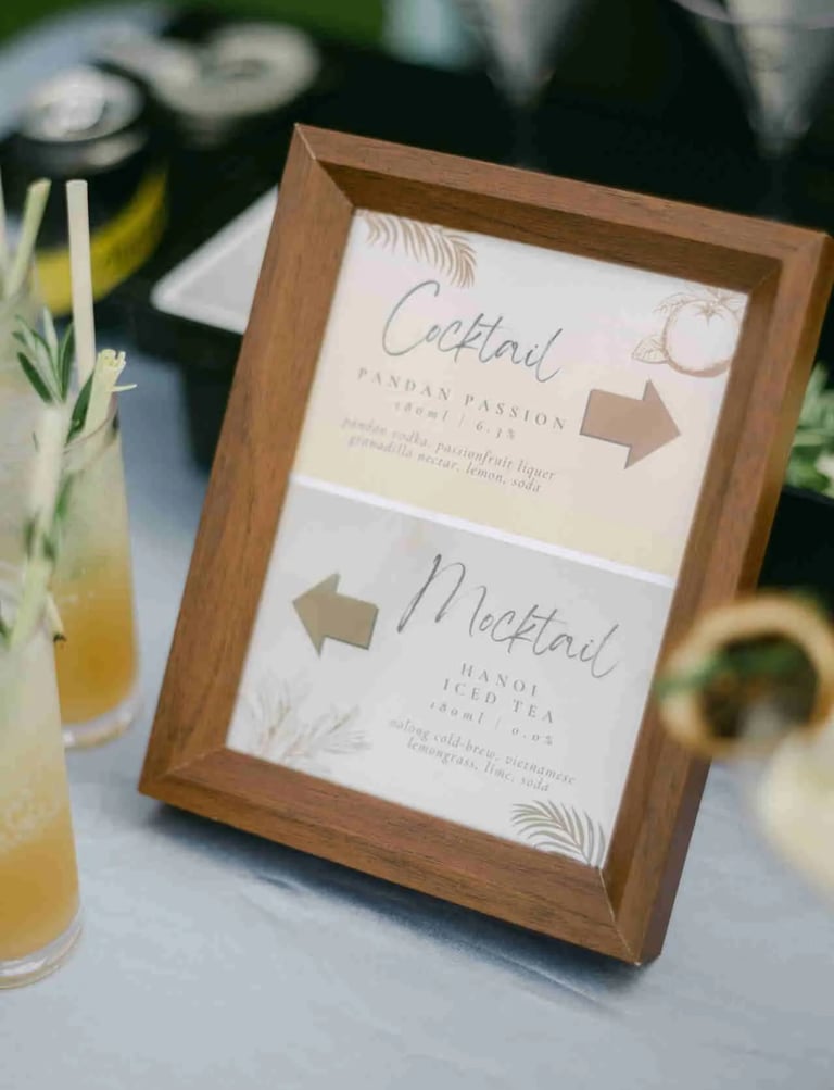 Personalized event cocktail menu frame on a bar top at a Sai Kung HK wedding reception.