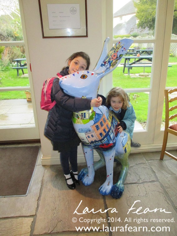 Large Hare sculpture painted with street scenes of Cirencester