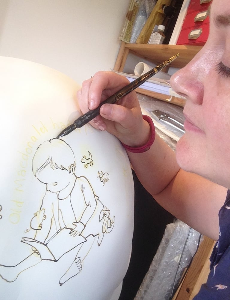Laura Fearn painting an owl for Owls of Bath