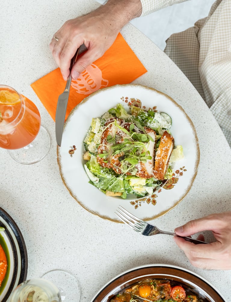 man eating a Caesar salad