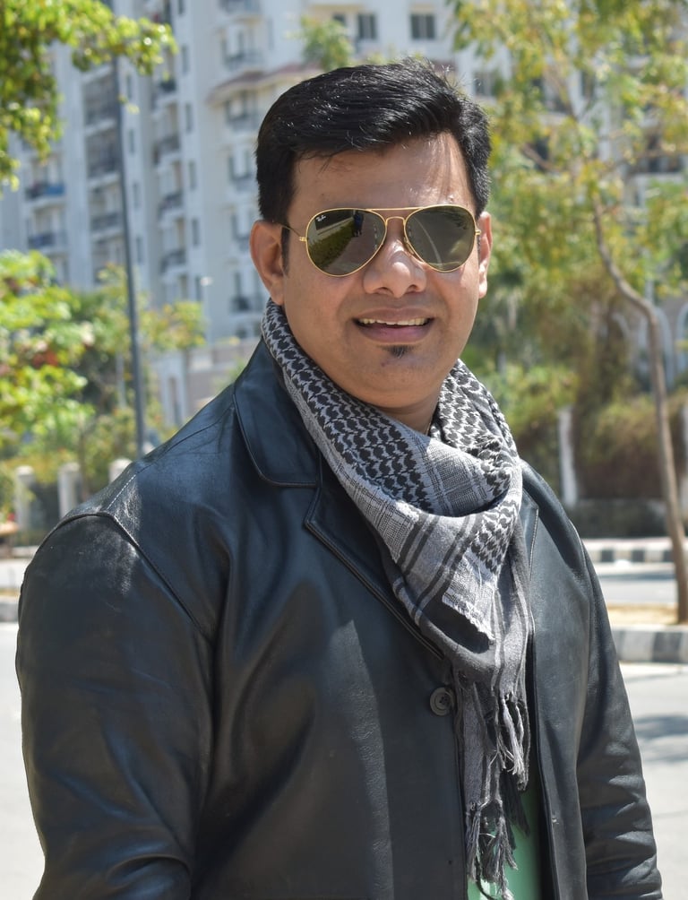 a man in a black jacket and sunglasses, raheel ahmed