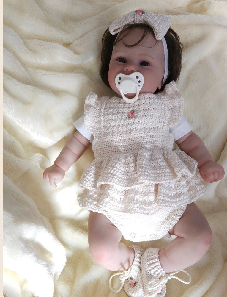 a baby girl wearing a white dress and pacifier pacifier pacifier pacifier