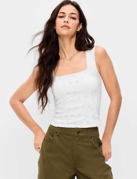 A woman wearing a white eyelet square-neck tank top and olive green cargo pants from old navy