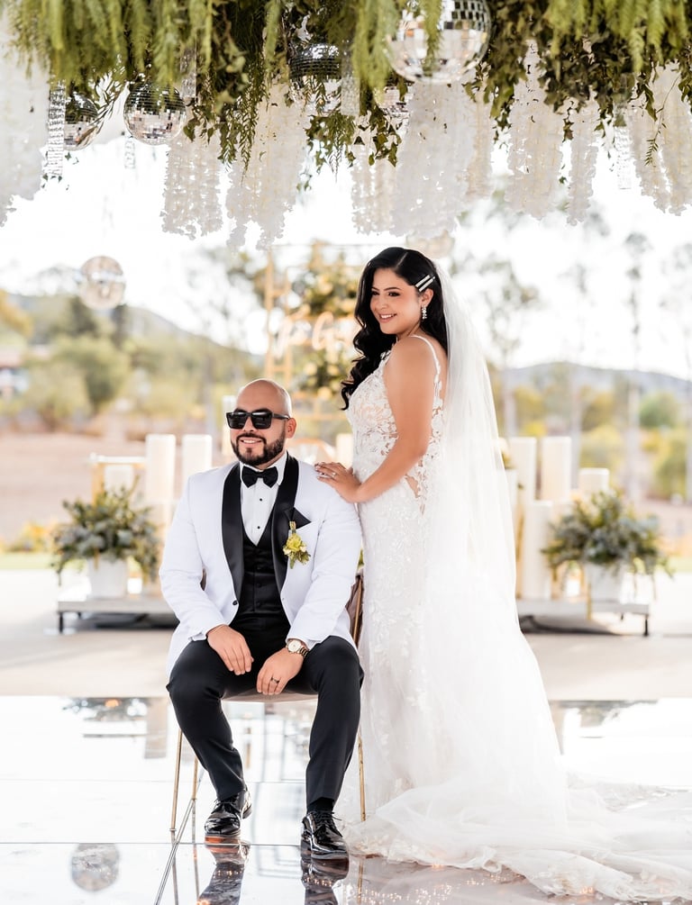 a bride and groom sitting on a chair in a wedding ceremony