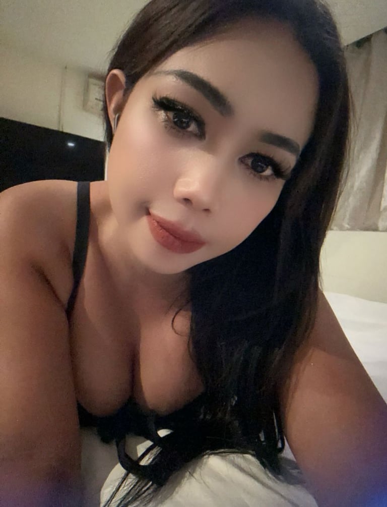 Lady therapist lying on bed taking a close up selfie