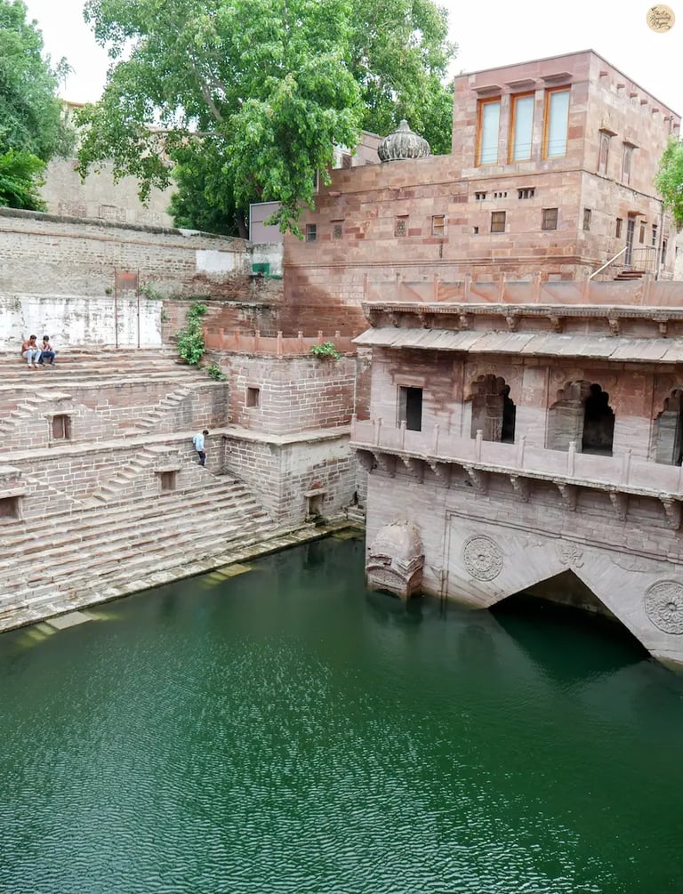 Toorji ka Jhalra stepwell in Jodhpur with intricate stone steps and glimmering water.