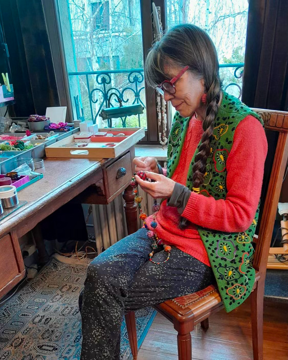 a woman sitting on a chair in a creative room