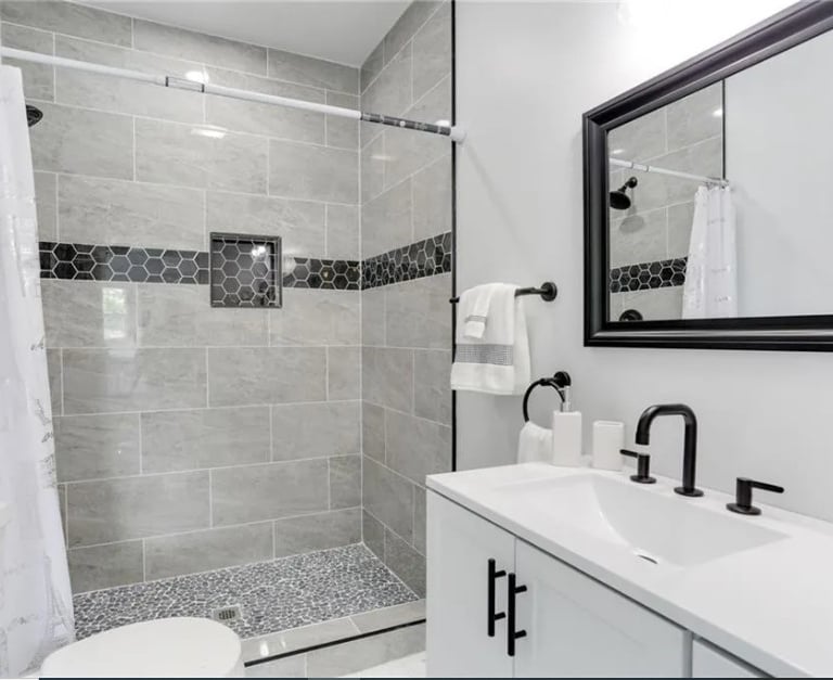 Completed bathroom remodel in Norfolk with new tile, fixtures, and lighting