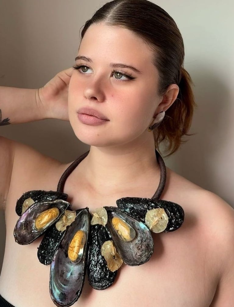 a woman with a necklace and a necklace