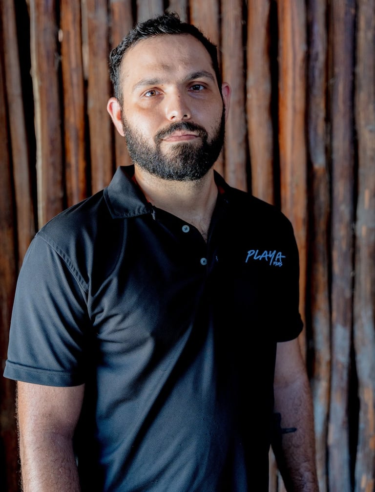 Sebastian Serrano wearing a Playa Films t-shirt, showcasing the video production team in Playa del C